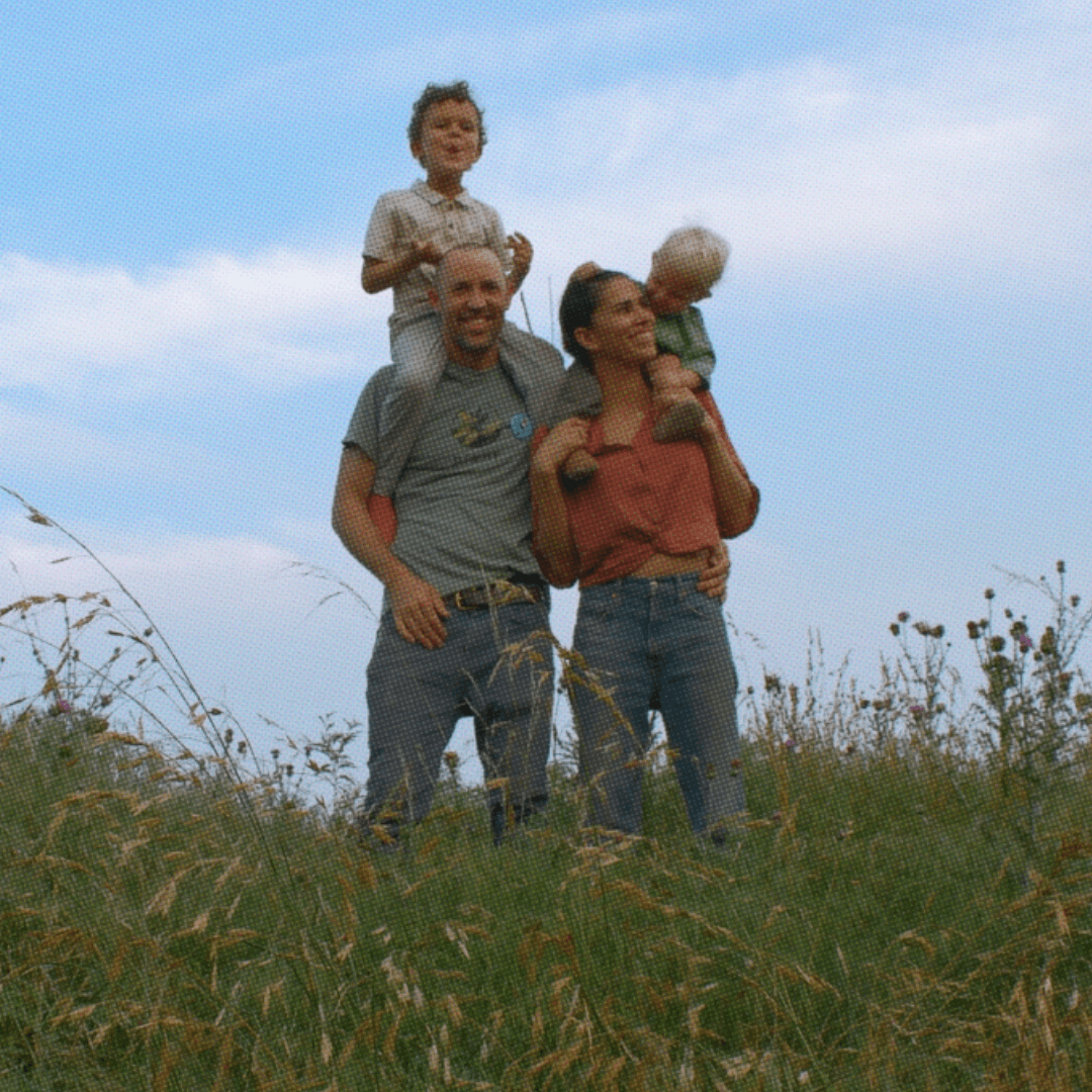American family standing together in a field, representing the health and unity that MAHA Center promotes